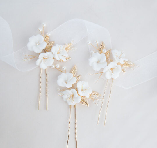 Pics avec fleurs blanches pour coiffure de mariage doré ou argenté